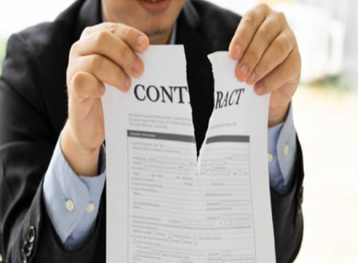 Person in a suit tearing up a document titled “Contract”
